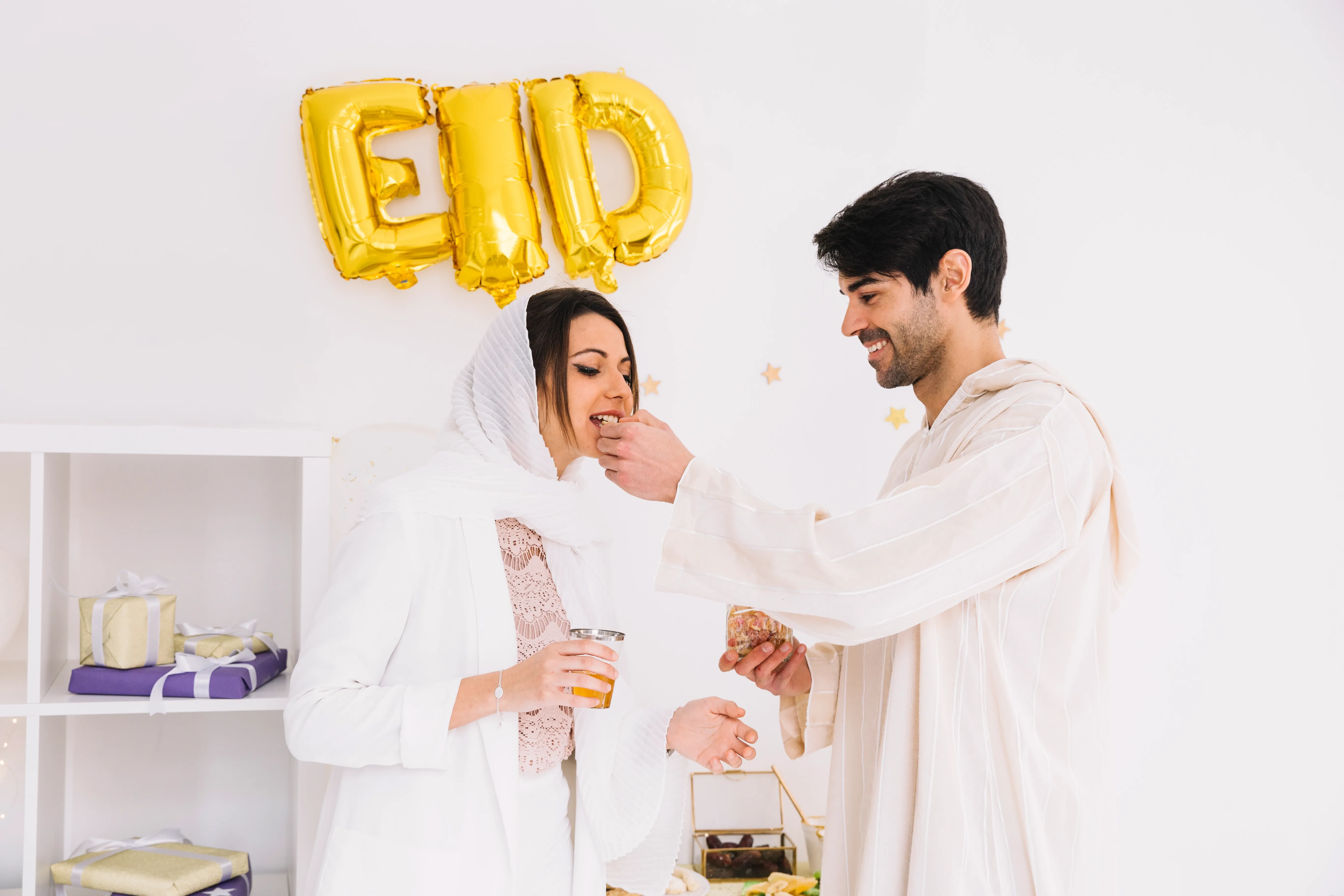 eid-al-fitr-concept-with-couple-eating-cookies.webp